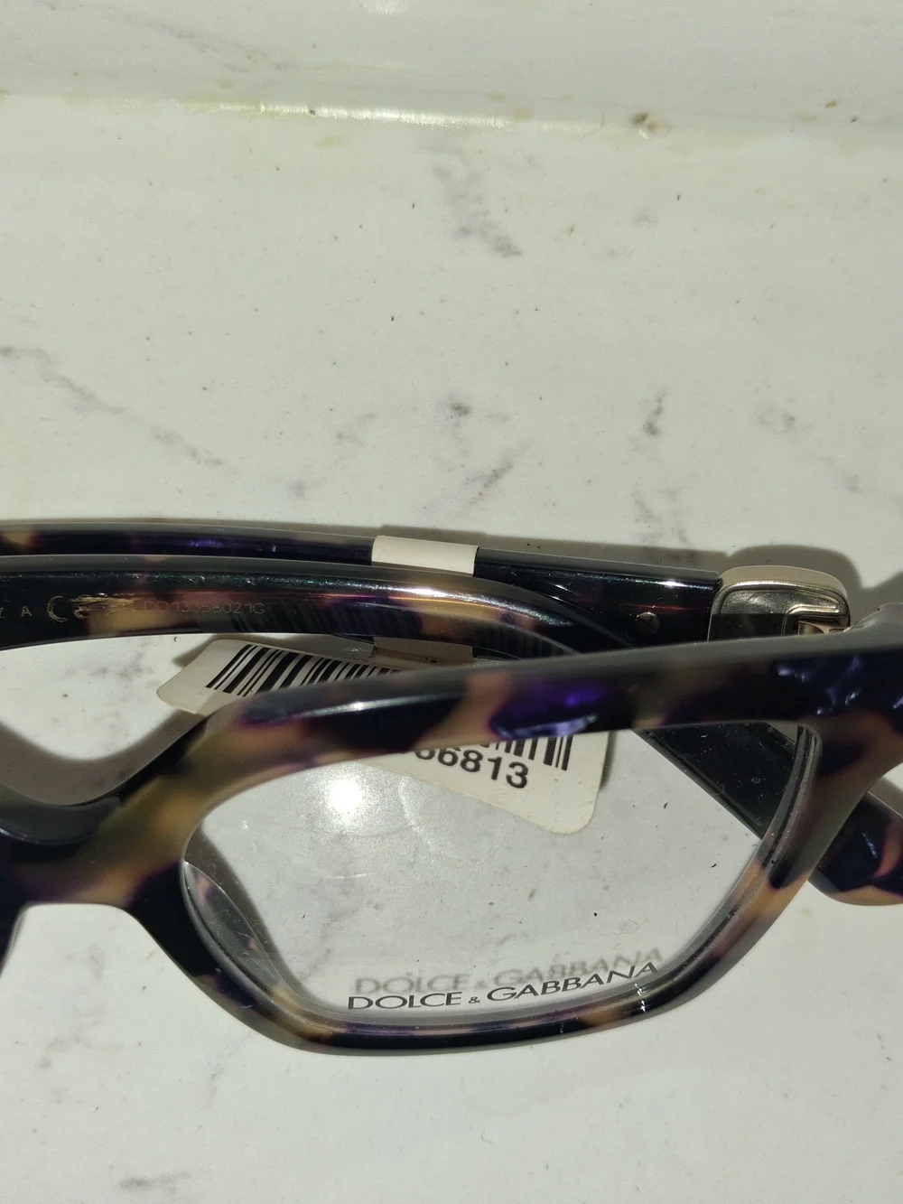 Dolce & Gabbana DG3395 eyeglasses feature a striking Havana Blue Pearl tortoises